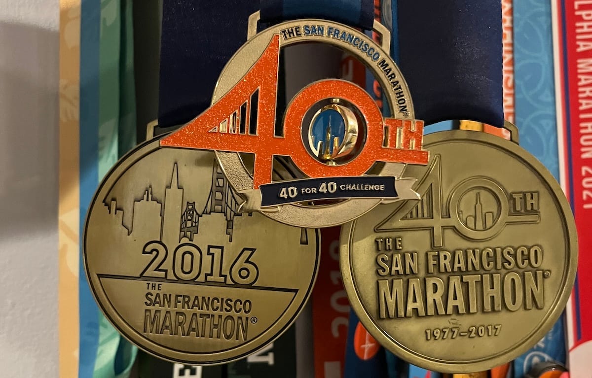 Three bronze-colored race medals side-by-side